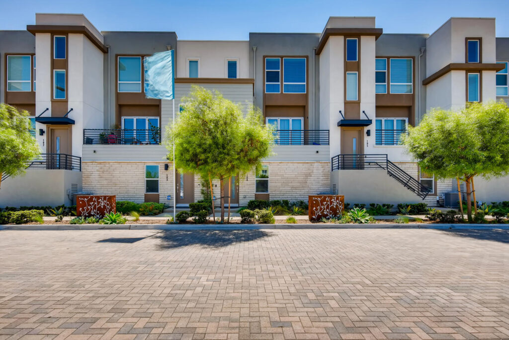 Building exterior with landscaped sidewalks and private balconies