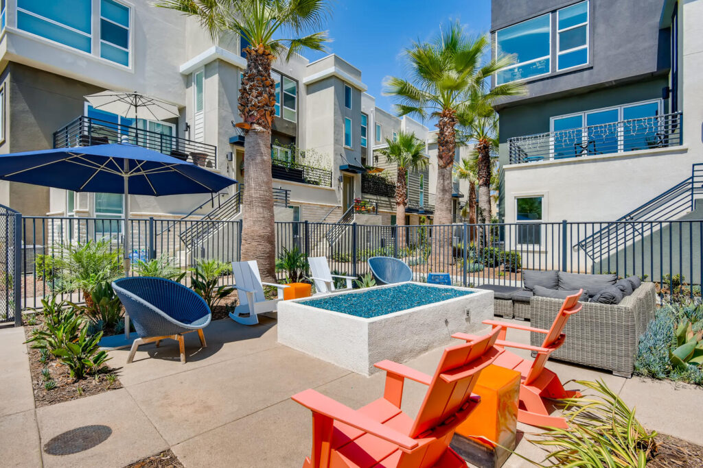 Sitting area by the pool with chairs around a fire pit