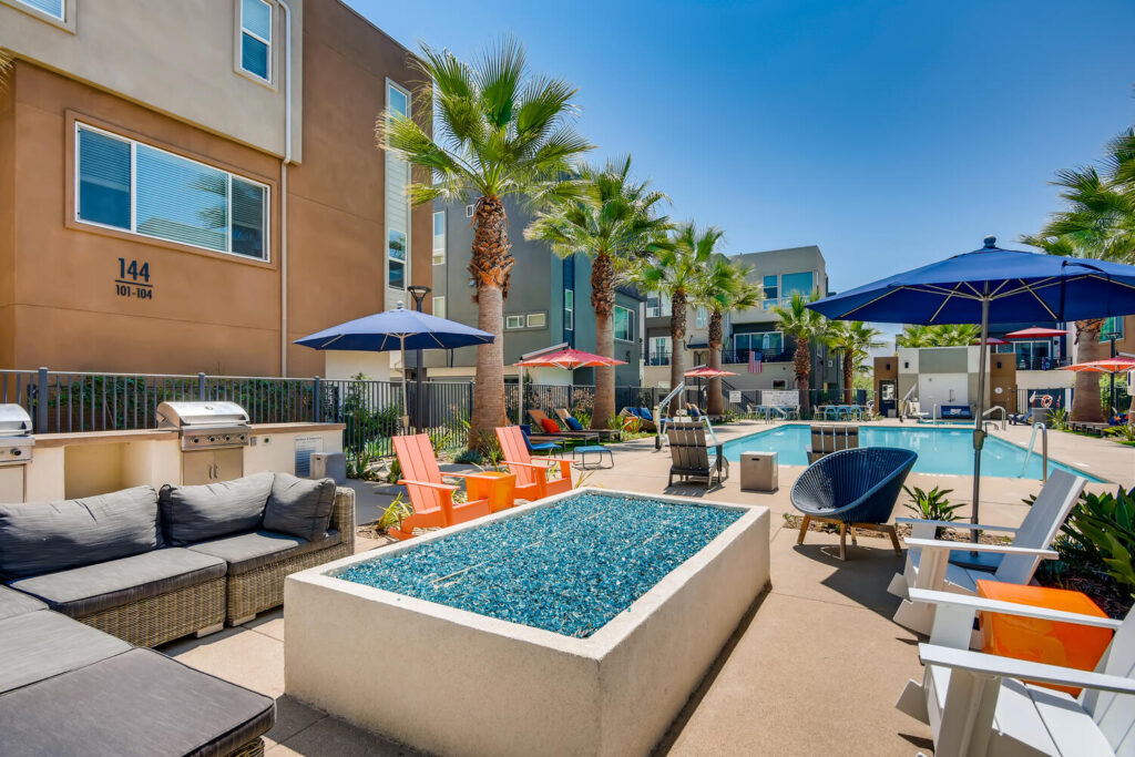 Sitting area by the pool with chairs around a fire pit