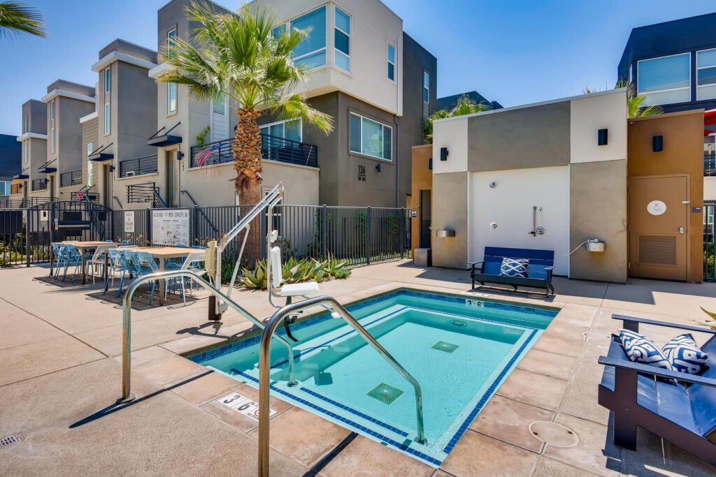 small pool with deck chairs and handicap accessible chair lift