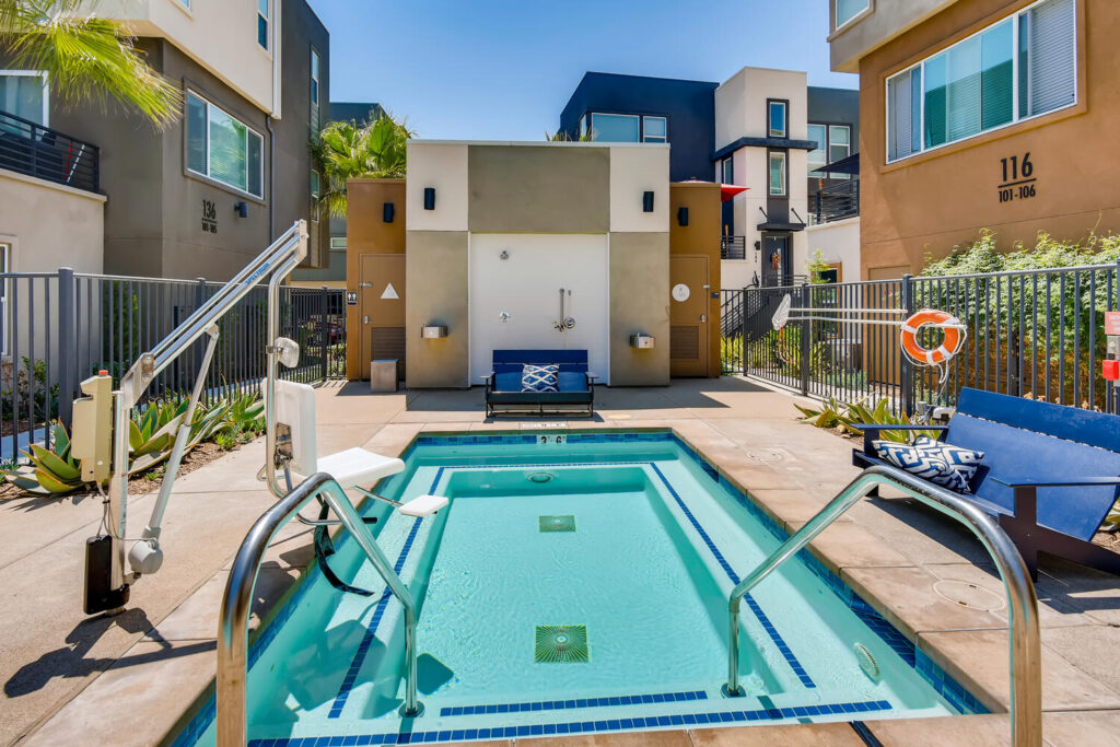small pool with deck chairs and handicap accessible chair lift